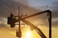 Silhouette electrician works on bucket