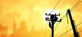 Silhouette electricians team with crane are working to install electrical transmission equipment on power pole Royalty Free Stock Photo