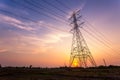 Silhouette electricity high voltage pole on sunset background