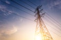 Silhouette electricity high voltage pole on sunset background