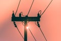 Silhouette of electricity pole and high voltage power line with sunset in the background. Royalty Free Stock Photo