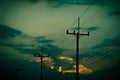 Silhouette electricity post with beautiful sunset background.