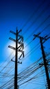 A Silhouette of Electricity post in dark blue sky background Royalty Free Stock Photo