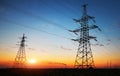 Silhouette of electricity pylons and high-voltage power lines on Royalty Free Stock Photo