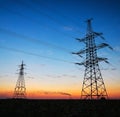 Silhouette of electricity pylons and high-voltage power lines on Royalty Free Stock Photo