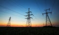 Silhouette of electricity pylons and high-voltage power lines Royalty Free Stock Photo