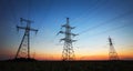 Silhouette of electricity pylons and high-voltage power lines Royalty Free Stock Photo