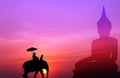 Silhouette elephant with tourist with big buddha background at s