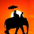Silhouette elephant with tourist at sunset Royalty Free Stock Photo