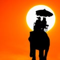 Silhouette elephant with tourist at sunset Royalty Free Stock Photo