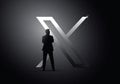 Silhouette of Elon Musk in front of X logo formerly known as Twitter