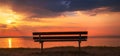 Silhouette of empty bench on Aegean sea shoreline in summer sunrise Royalty Free Stock Photo