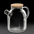 Silhouette of an empty glass teapot on a black background.