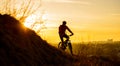 Silhouette of Enduro Cyclist Riding the Mountain Bike on the Rocky Trail at Sunset. Active Lifestyle Concept. Space for Text. Royalty Free Stock Photo