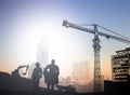 Silhouette engineer in a building site over Blurred constructio Royalty Free Stock Photo