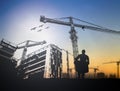 Silhouette engineer in a building site over Blurred constructio Royalty Free Stock Photo