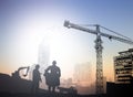 Silhouette engineer in a building site over Blurred constructio Royalty Free Stock Photo