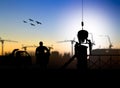 silhouette engineer looking at blueprints in a building site over Blurred construction worker Royalty Free Stock Photo