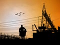 silhouette engineer looking at blueprints in a building site over Blurred substation Royalty Free Stock Photo