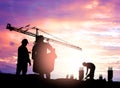 Silhouette engineer looking construction worker under tower cran in a building site over Blurred construction worker on construct Royalty Free Stock Photo