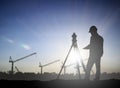 Silhouette engineer looking Loaders and trucks in a building sit Royalty Free Stock Photo