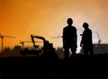 Silhouette engineer looking Loaders and trucks in a building sit Royalty Free Stock Photo