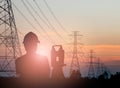 Silhouette engineer looking Loaders and trucks in a building sit