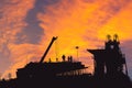 Silhouette of Engineer and worker checking project at building site background, construction site at sunset in evening time Royalty Free Stock Photo