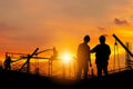 Silhouette of Engineer and worker with clipping path on building site, construction site at sunset in evening time Royalty Free Stock Photo
