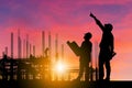Silhouette of Engineer and worker with clipping path on building site, construction site at sunset in evening time Royalty Free Stock Photo