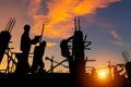 Silhouette of Engineer and worker team checking project at building site background, construction site with sunset in evening time Royalty Free Stock Photo