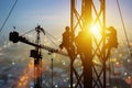 Silhouette of Engineer and worker working crane on steel structures industrial project at building site background, construction Royalty Free Stock Photo