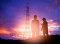 Silhouette engineer working in a building site over Blurred co