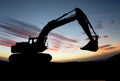 Silhouette of Excavator loader at construction site with raised Royalty Free Stock Photo
