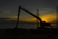 Silhouette of Excavator loader at construction site