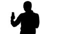 Silhouette Exprecive talk on the phone of a man. Videoblog, blog, vlog. Royalty Free Stock Photo