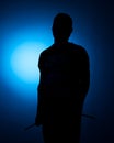 Silhouette Expressive young drummer with drum stick on a blue background Royalty Free Stock Photo