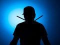 Silhouette Expressive young drummer with drum stick on a blue background