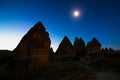 Silhouette of Fairy Chimneys or Peri Bacalari and Moon at Sunrise