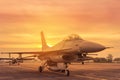 Silhouette Falcon Fighter Jet Military Aircraft Parked On Runway In Sunset