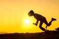 Silhouette of falling boy from bicycle, teenager was making trick on bycicle Royalty Free Stock Photo