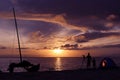 Silhouette family camping on the beach with sailboat. Royalty Free Stock Photo