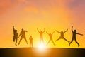 Silhouette of a Family with children and friend playing with sunset background