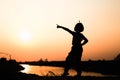 Silhouette of a family comprising a father, mother and two children happy family the sunset.Concept of friendly Royalty Free Stock Photo