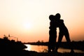 Silhouette of a family comprising a father, mother and two children happy family the sunset.Concept of friendly Royalty Free Stock Photo