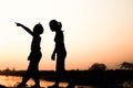 Silhouette of a family comprising a father, mother and two children happy family the sunset.Concept of friendly Royalty Free Stock Photo