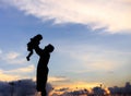 Silhouette of a family comprising a father, mother and two children happy family the sunset.Concept of friendly Royalty Free Stock Photo