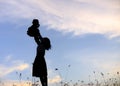 Silhouette of a family comprising a father, mother and two children happy family the sunset.Concept of friendly Royalty Free Stock Photo