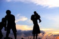 Silhouette of a family comprising a father, mother and two children happy family the sunset.Concept of friendly