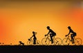 Silhouette of family driving bike with beautiful sky at sunset .